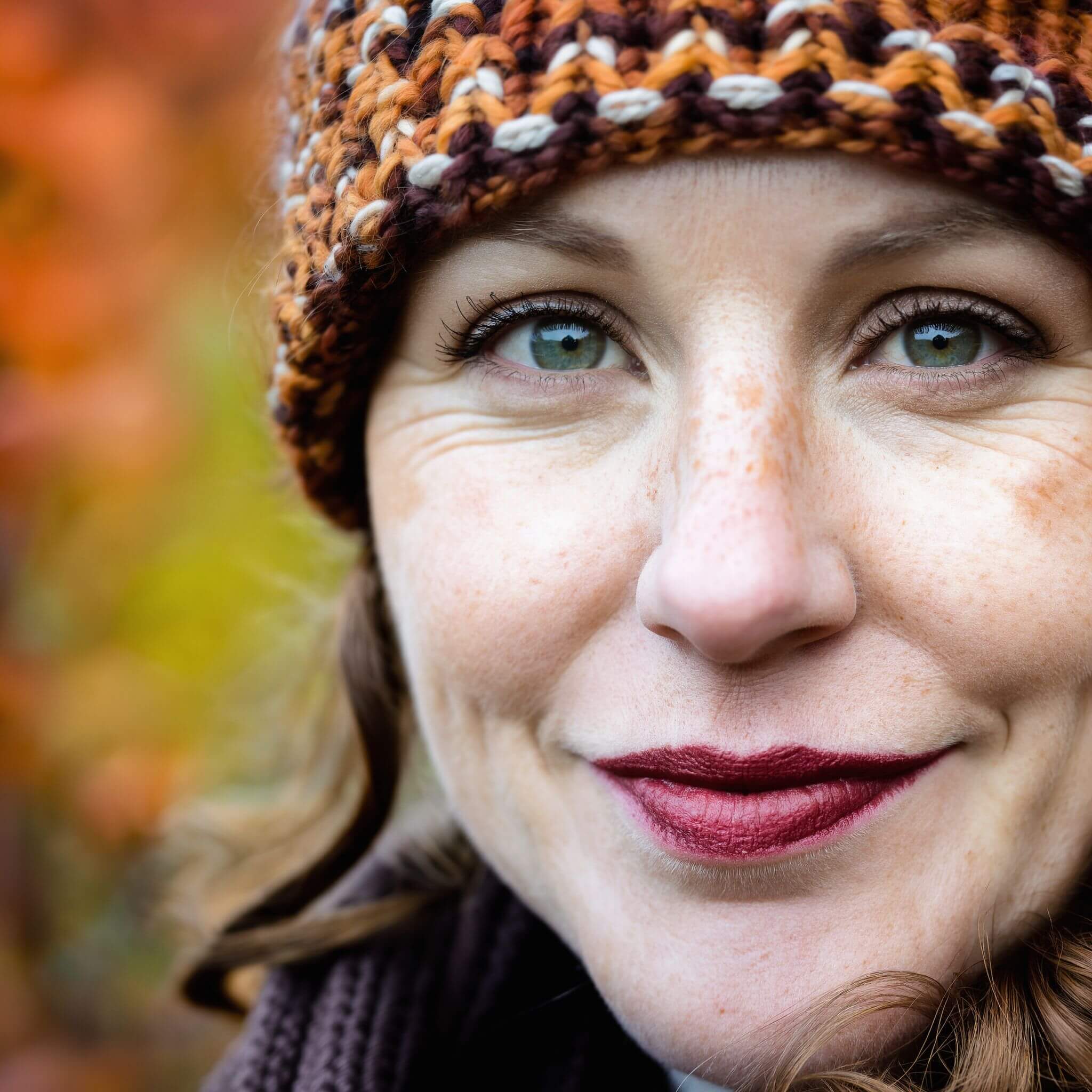 Close-up portrait shot of a woman in autumn, extreme detail, shallow depth of field